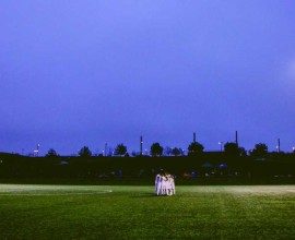 Soccer Players huddled under the lights